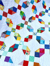 Load image into Gallery viewer, Rainbow scrappy quilt.
