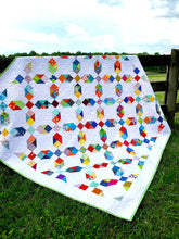 Load image into Gallery viewer, Rainbow scrappy quilt.
