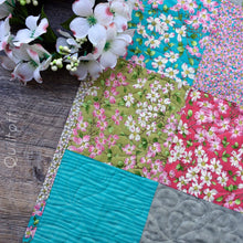 Load image into Gallery viewer, Available now: baby quilt, bright, scrappy look, floral, dogwood
